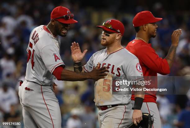 Kole Calhoun of the Los Angeles Angels of Anaheim is congratulated by teammate Jabari Blash after their MLB game against the Los Angeles Dodgers at...