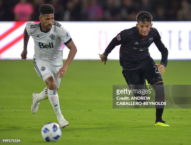 Yamil Asad of DC United vies for the ball with Sean Franklin during the DC United vs the Vancouver Whitecaps FC match in Washington DC on July 14,...