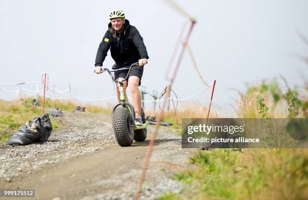 Tristan from Schwerin riding a monster scooter on Wurmberg mountain near Braunlage, Germany, 16 August 2017. Photo: Swen Pförtner/dpa