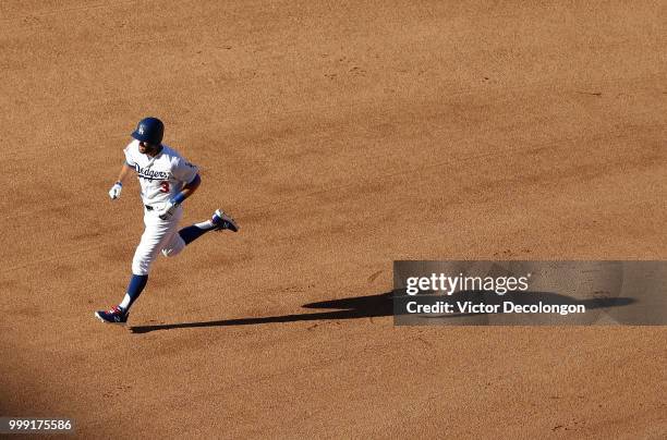 Chris Taylor of the Los Angeles Dodgers jogs on his approach to third base after hitting a solo homerun in the fifth inning during the MLB game...