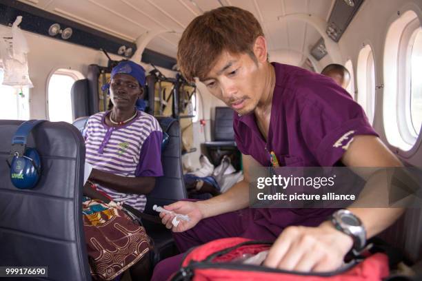 Nurse Yuki Asakura tends to 9-year-old Remaik, who has lost consciousness due to her bullet wound, on the Twin Otter plane evacuating her from Bor to...