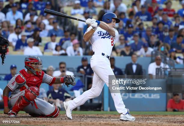 Chase Utley of the Los Angeles Dodgers hits a single to right field in the ninth inning during the MLB game against the Los Angeles Angels of Anaheim...