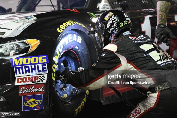The front tire changer goes to work on the Clint Bowyer Stewart-Haas Racing Ford Fusion during the Monster Energy NASCAR Cup Series Quaker State 400...