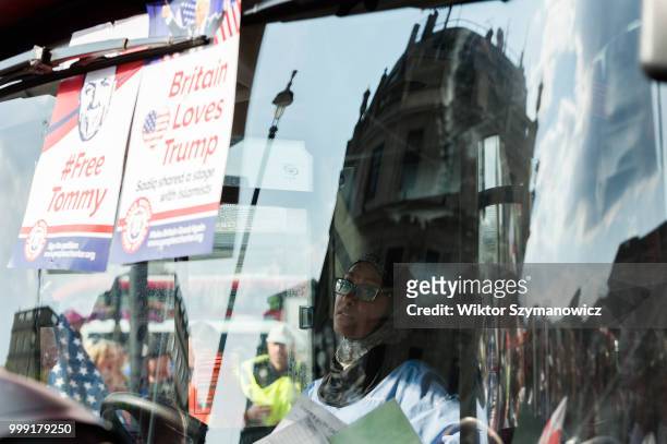 Supporters of far-right activist and former English Defence League leader Tommy Robinson block the path of a number 9 bus with a Muslim woman driver...