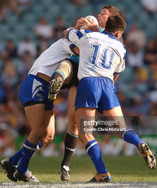 Andrew Pierce of the Sharks is tackled by Steven Price of the Bulldogs during the NRL second semi final match between the Bulldogs and the Cronulla...
