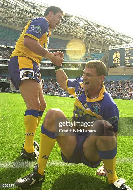 Ian Hindmarsh of Parramatta helps team mate Jason Moodie to his feet after his try during the NRL semi final between the Parramatta Eels and the...