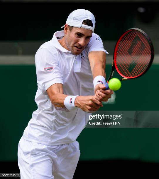 John Isner of the United States in action against Kevin Anderson of South Africa in the semi final of the gentlemen's singles at the All England Lawn...