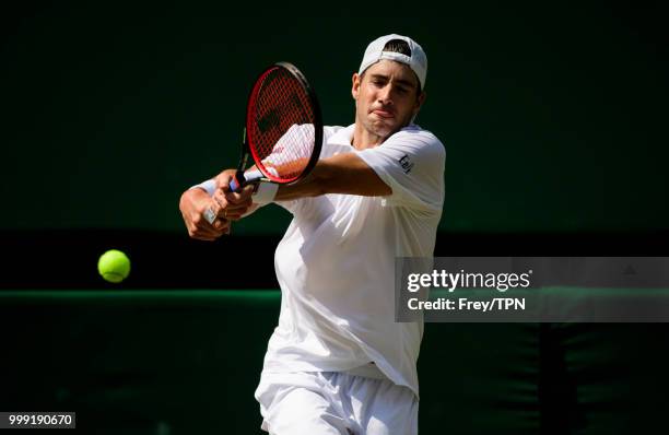 John Isner of the United States in action against Kevin Anderson of South Africa in the semi final of the gentlemen's singles at the All England Lawn...