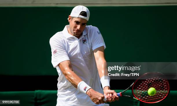 John Isner of the United States in action against Kevin Anderson of South Africa in the semi final of the gentlemen's singles at the All England Lawn...