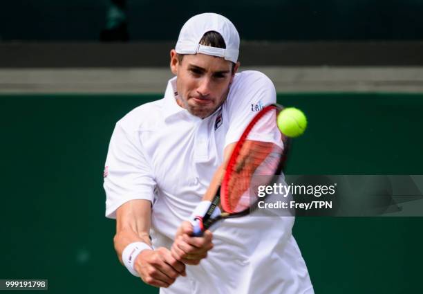 John Isner of the United States in action against Kevin Anderson of South Africa in the semi final of the gentlemen's singles at the All England Lawn...