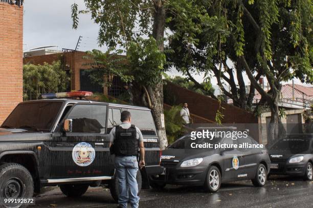 Member of the Venezuelan police seen next to a police vehicle as police search the apartment of ousted attorney general Luisa Ortega in Caracas,...
