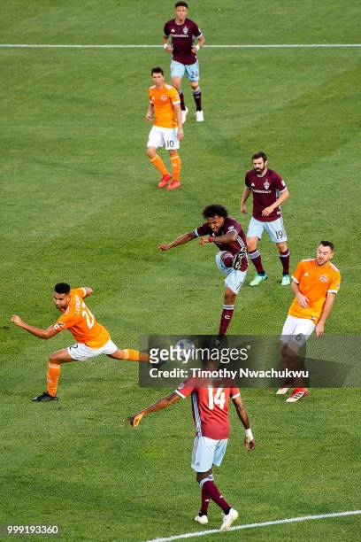 Giles Barnes of Colorado Rapids, center, attempts a shot against the Houston Dynamo at Dick's Sporting Goods Park on July 14, 2018 in Commerce City,...