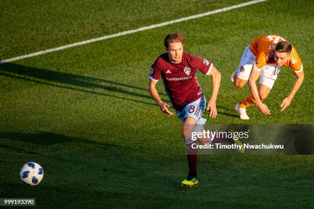 Johan Blomberg of Colorado Rapids dribbles past Adam Lundqvist of Houston Dynamo at Dick's Sporting Goods Park on July 14, 2018 in Commerce City,...