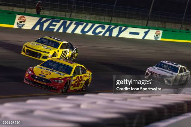 Joey Logano, driver of the Shell Pennzoil Ford, leads Landon Cassill, driver of the StarCom Fiber Chevrolet, and Erik Jones, driver of the...