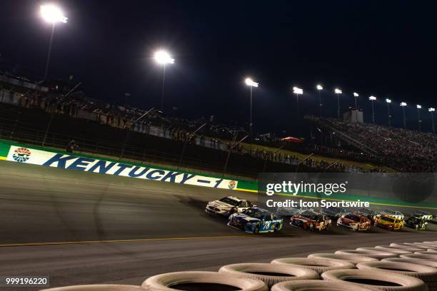 Martin Truex Jr., driver of the Auto-Owners Insurance Toyota, leads the pack on a restart into turn one during the Monster Energy NASCAR Cup Series...