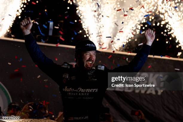 Martin Truex Jr., driver of the Auto-Owners Insurance Toyota, celebrates after winning the Monster Energy NASCAR Cup Series Quaker State 400...