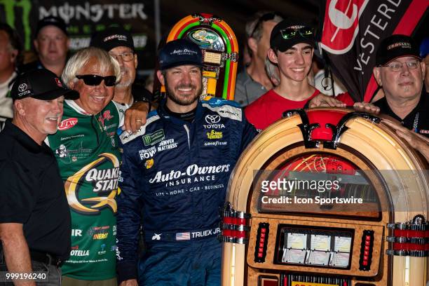 Martin Truex Jr., driver of the Auto-Owners Insurance Toyota, poses with a Crosley jukebox he was given after winning the Monster Energy NASCAR Cup...
