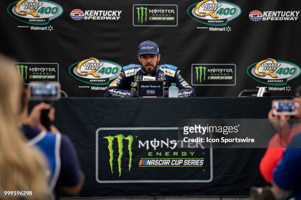 Martin Truex Jr., driver of the Auto-Owners Insurance Toyota, answers questions for the media after winning the Monster Energy NASCAR Cup Series...