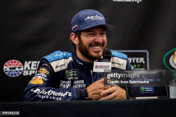 Martin Truex Jr., driver of the Auto-Owners Insurance Toyota, smiles as he answers questions for the media after winning the Monster Energy NASCAR...