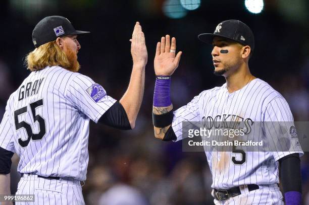 Carlos Gonzalez and Jon Gray of the Colorado Rockies celebrate a 4-1 win over the Seattle Mariners after a game at Coors Field on July 14, 2018 in...