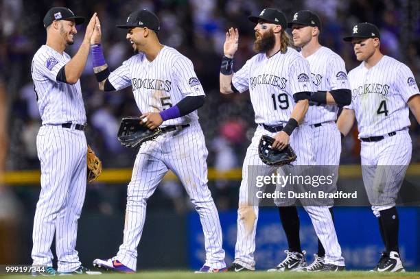 Nolan Arenado, Carlos Gonzalez, Charlie Blackmon, Trevor Story, and Pat Valaika of the Colorado Rockies celebrate after a 4-1 win over the Seattle...