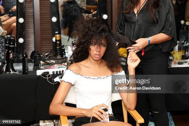 Model prepares backstage for Kaohs during the Paraiso Fashion Fair at The Setai Miami Beach on July 14, 2018 in Miami Beach, Florida.