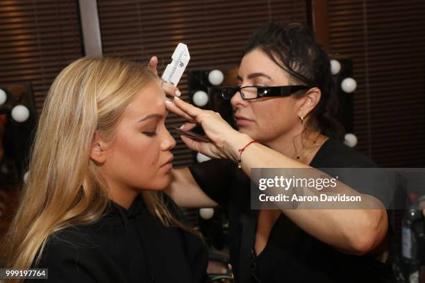 Model prepares backstage for Kaohs during the Paraiso Fashion Fair at The Setai Miami Beach on July 14, 2018 in Miami Beach, Florida.