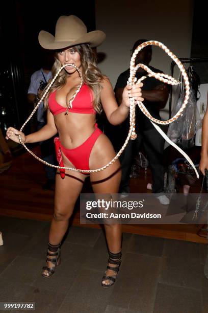 Model prepares backstage for Kaohs during the Paraiso Fashion Fair at The Setai Miami Beach on July 14, 2018 in Miami Beach, Florida.