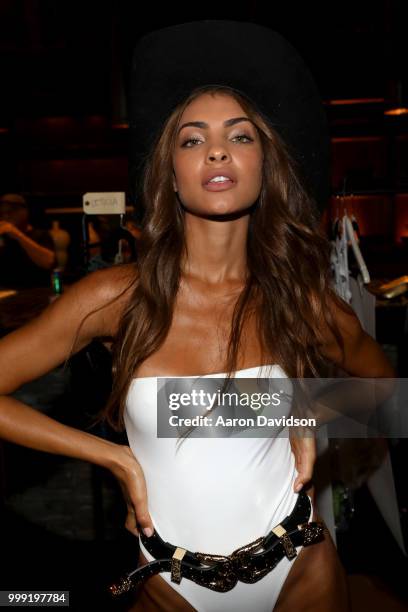 Model prepares backstage for Kaohs during the Paraiso Fashion Fair at The Setai Miami Beach on July 14, 2018 in Miami Beach, Florida.