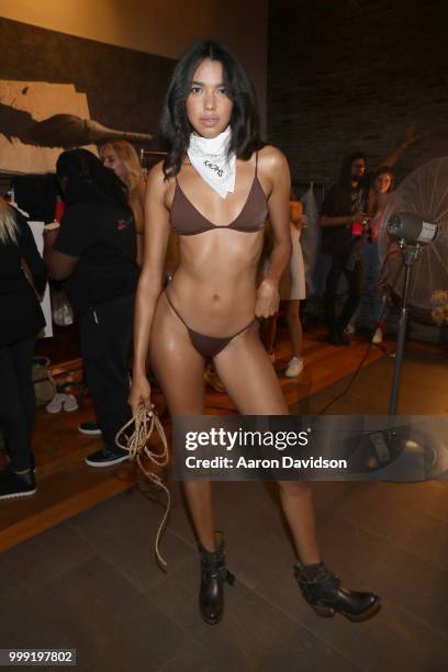 Model prepares backstage for Kaohs during the Paraiso Fashion Fair at The Setai Miami Beach on July 14, 2018 in Miami Beach, Florida.