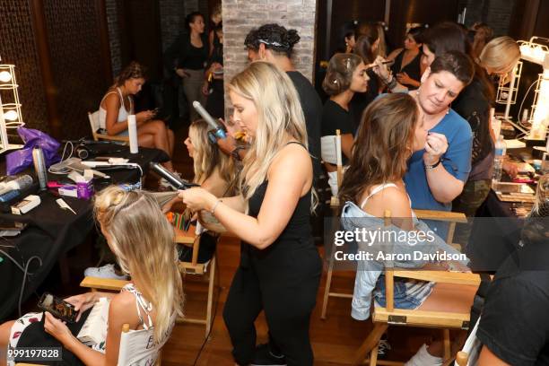Models prepare backstage for Kaohs during the Paraiso Fashion Fair at The Setai Miami Beach on July 14, 2018 in Miami Beach, Florida.