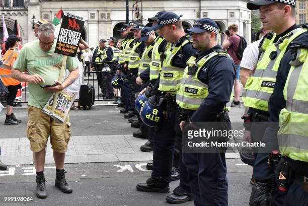 Anti fascists demonstrate against the Free Tommy Robinson event on Whitehall, police officers keep the groups apart.