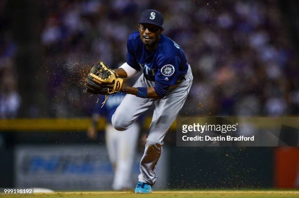 Dee Gordon of the Seattle Mariners moves to throw to first base for an out after fielding a ground ball against the Colorado Rockies at Coors Field...