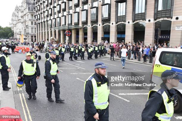 Anti fascists demonstrate against the Free Tommy Robinson event on Whitehall, police officers keep the groups apart.