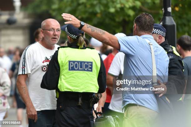 Anti fascists demonstrate against the Free Tommy Robinson event on Whitehall, police officers keep the groups apart.