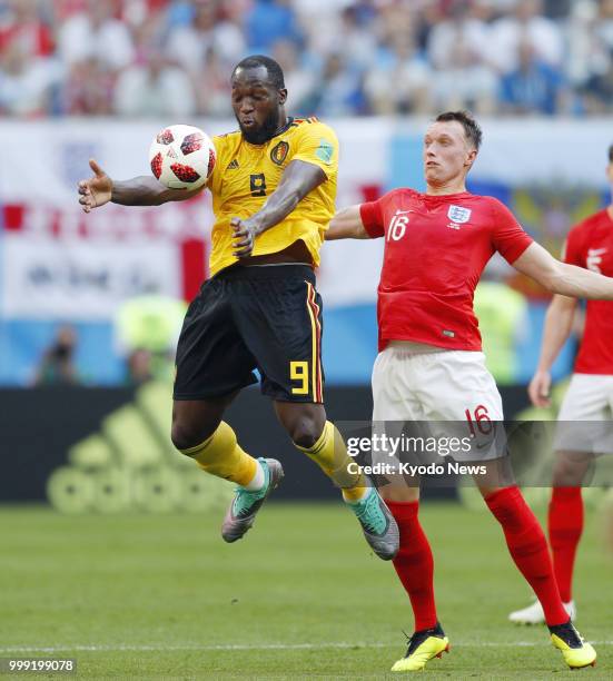 Romelu Lukaku of Belgium traps the ball near Phil Jones of England during the first half of a World Cup playoff for third place at Saint Petersburg...