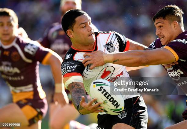 Isaac Luke of the Warriors offloads during the round 18 NRL match between the Brisbane Broncos and the New Zealand Warriors at Suncorp Stadium on...