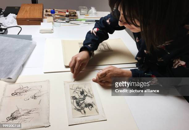 Dorothea Spitza, curator, inspecting a Liebermann drawing in order to attest of what materials the residues of adhesive are made, in the Art Museum...