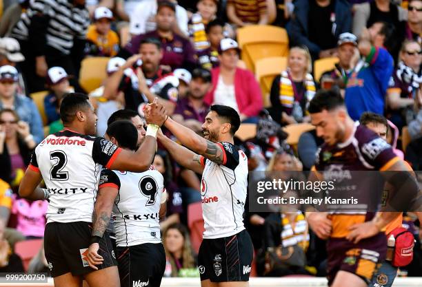 Gerard Beale of the Warriors is congratulated by team mates after scoring a try during the round 18 NRL match between the Brisbane Broncos and the...