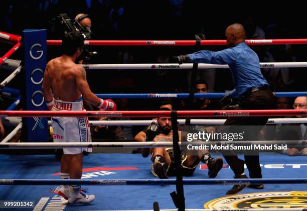 Argentina's Lucas Matthysse fall during fight with Philippine's Manny Pacquiao for their World welterweight boxing championship title bout in Kuala...