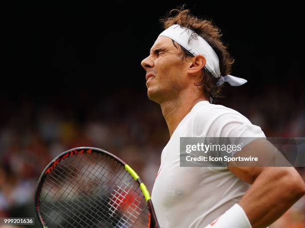 Rafael Nadal reacts after loosing a point in the 5th set during the men's singles semi final at the Wimbledon Championships on July 14, 2018 played...