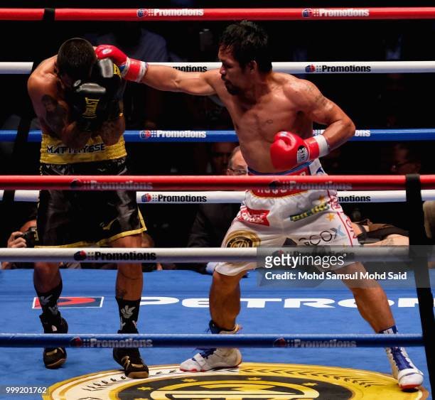 Philippine's Manny Pacquiao fight with Argentina's Lucas Matthysse during their World welterweight boxing championship title bout in Kuala Lumpur,...