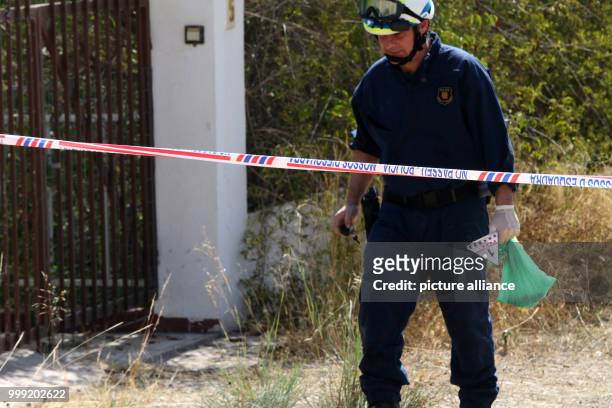 Police officer gathers evidence after the explosion of a house in Alcanar, Spain, 17 August 2017. The incident in the small town is connected to the...