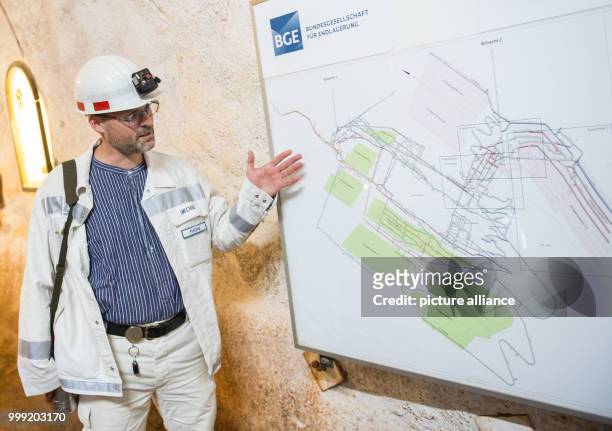Christian Fuchs, plant engineer of the Deutsche Gesellschaft zum Bau und Betrieb von Endlagern für Abfallstoffe points to a map of the shaft Konrad...
