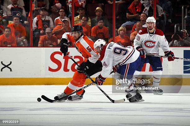 Tom Pyatt of the Montreal Canadiens fights for the puck against Braydon Coburn of the Philadelphia Flyers in Game 1 of the Eastern Conference Finals...