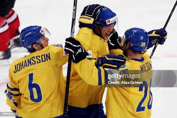 Victor Hedman of Sweden celebrates his team's third goal with team mates Magnus Johansson and Marcus Nilson during the IIHF World Championship group...