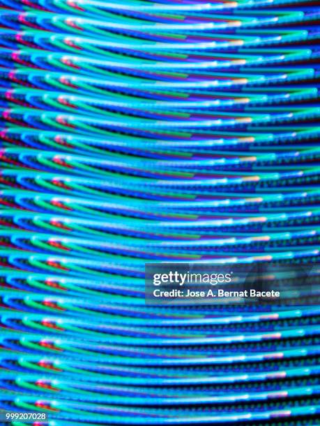 close-up abstract pattern of intertwined colorful light beams of color light blue and dark blue on a  black background. - bernat bacete imagens e fotografias de stock