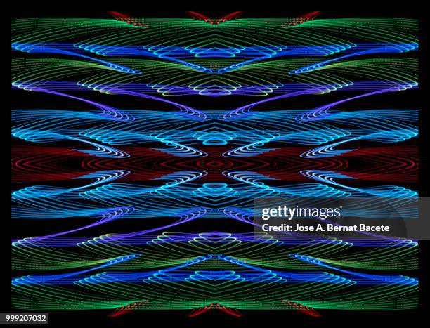 close-up abstract pattern of intertwined colorful light beams of color blue, green and pink on a  black background. - bernat photos et images de collection