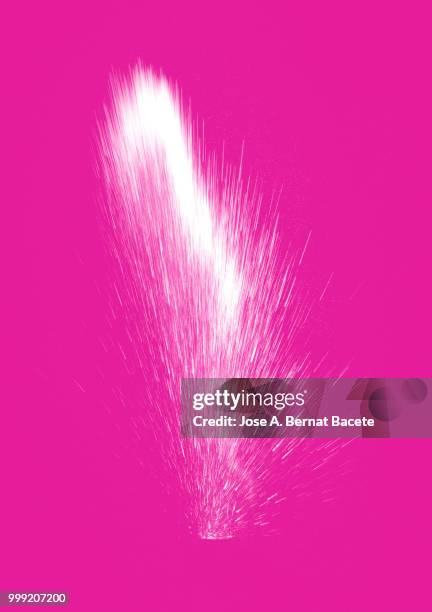 explosion by an impact of a cloud of particles of powder of color white on a pink background. - bernat bacete imagens e fotografias de stock