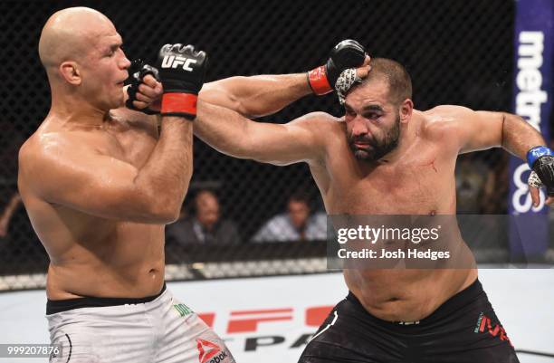 Blagoy Ivanov punches Junior Dos Santos of Brazil in their heavyweight fight during the UFC Fight Night event inside CenturyLink Arena on July 14,...
